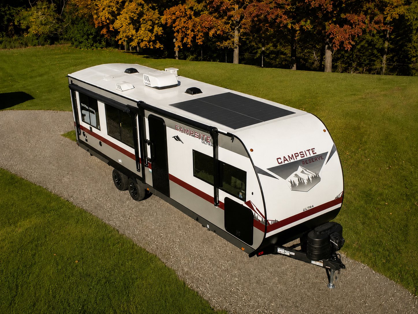 Off-road camping trailer with integrated solar at a lakeside camp
